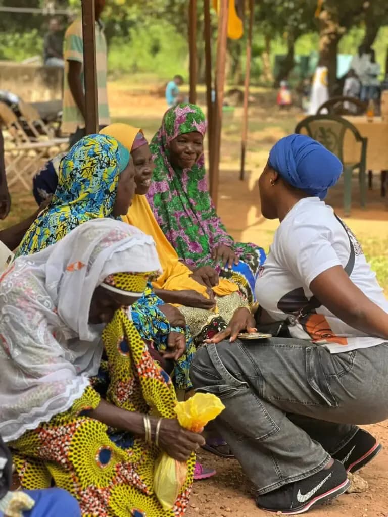 Maltiti Foundation team member listening to women during community outreach